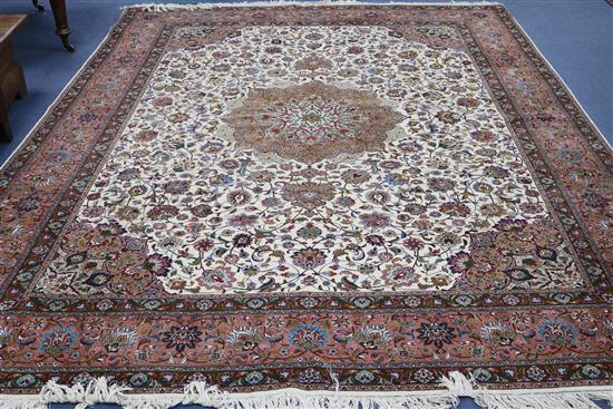 A Tabriz cream ground medallion carpet 400 x 305cm